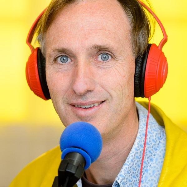 A person wearing red headphone with a bright yellow background